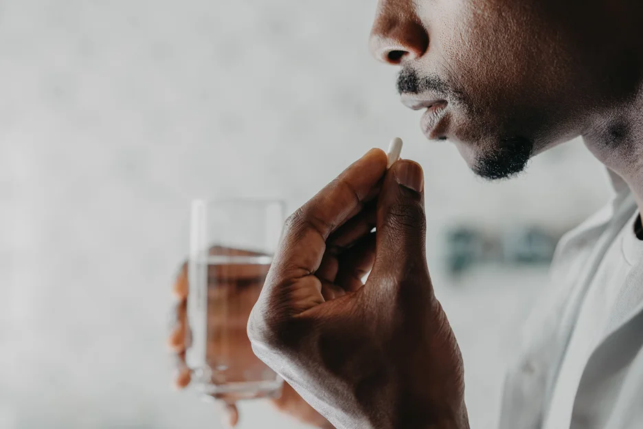 a man taking a pill