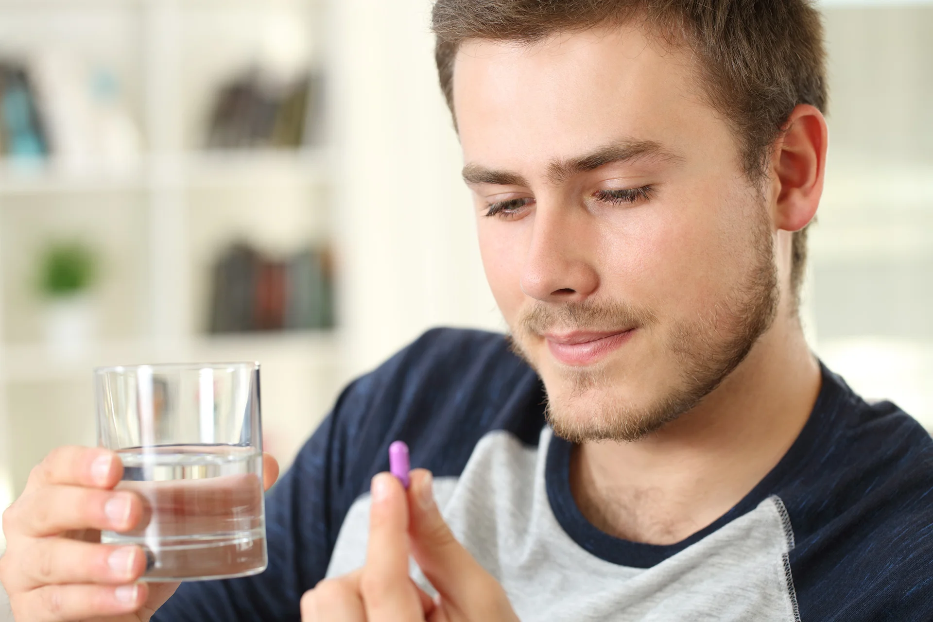 a man taking a pill